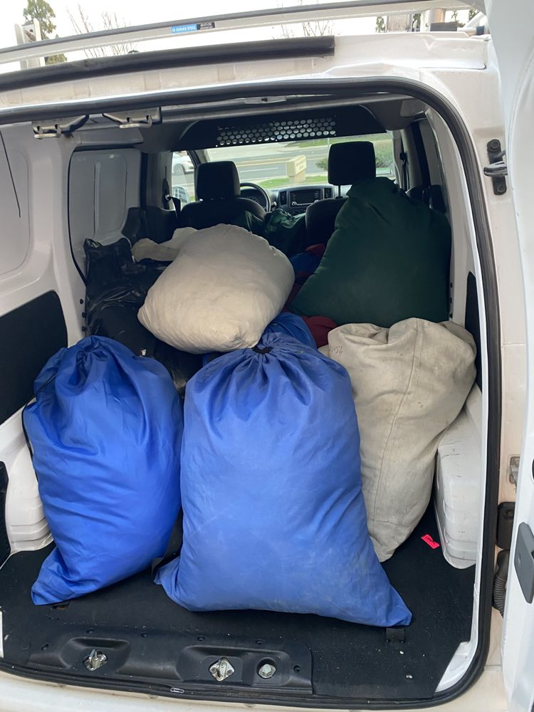 Delivery van loaded with laundry bags